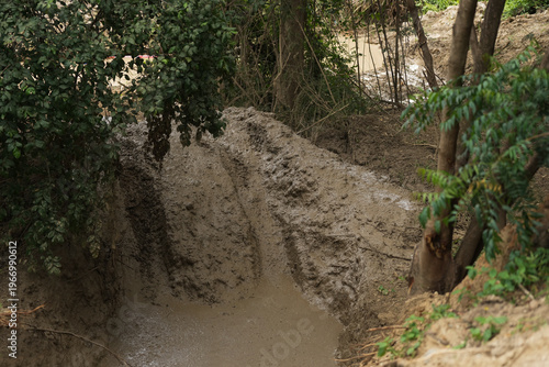 Red Pickup off road  4WD spin mud dirty track on mountain hill.     