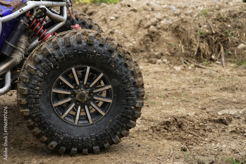  SUV Car racing offroad wheels on steppe terrain splashing with dirt offroad car in action. Dirty car drive high speed on mud gravel road. Provide the best experience off road travel concept big 4x4.