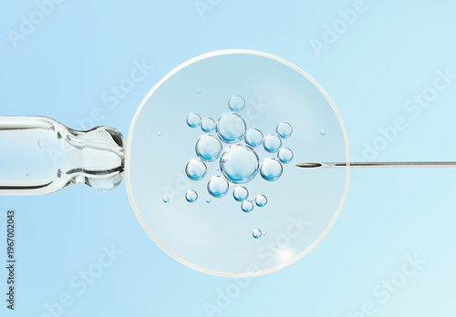 Photos An embryonic cell, a pipette, and a needle on a light blue background