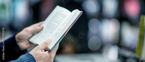 Wallpaper Mural Man reading book in the city street, detail on the hands Torontodigital.ca