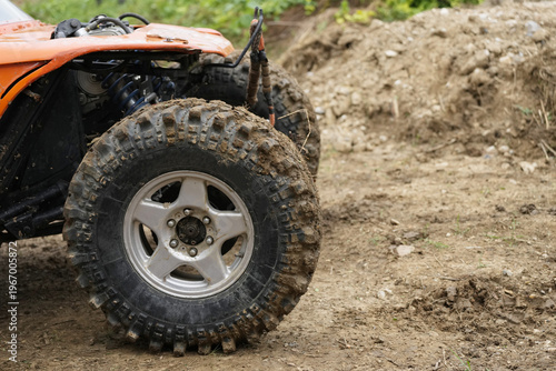  SUV Car racing offroad wheels on steppe terrain splashing with dirt offroad car in action. Dirty car drive high speed on mud gravel road. Provide the best experience off road travel concept big 4x4.