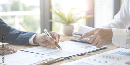 Business negotiations and financial agreements with the hand that is reviewing and signing important documents