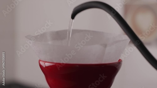 Rinsing paper filter in red V60 with gooseneck kettle
