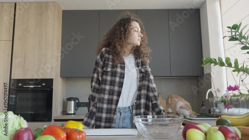 Thoughtful Woman Looking Through Window In Home Kitchen Interior