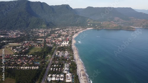 Aerial 4K wide view of Maresias beach coastline and mountains in Sao Sebastiao, Brazil