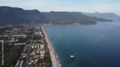 Aerial 4K wide view of Maresias beach coastline and mountains in Sao Sebastiao, Brazil