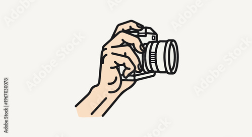 Hand holding a modern camera, ready to capture a moment