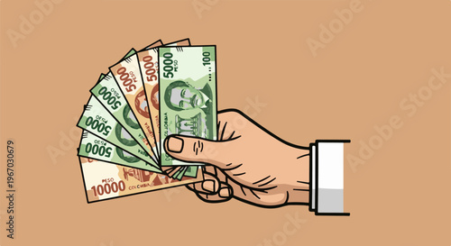 Hand holding fanned banknotes of various denominations