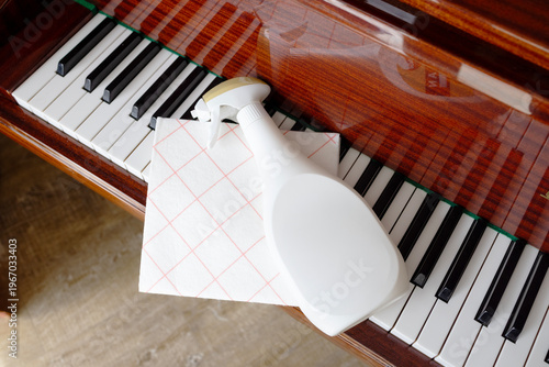 Cleaning piano keyboard with spray and cloth delicate care maintenance dust removal instrument care