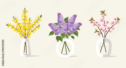 Three elegant glass vases containing branches of yellow forsythia, purple lilac, and pink cherry blossoms on a beige background.