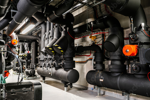 Industrial HVAC system with insulated pipelines and distribution units in plant room