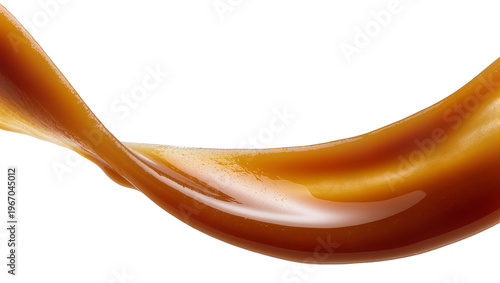 Photography Thick viscous caramel sauce flowing in a smooth wave, isolated on transparent ba
