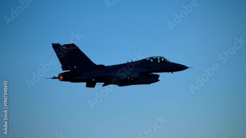 Jet Fighter Silhouette Flying Against Blue Sky