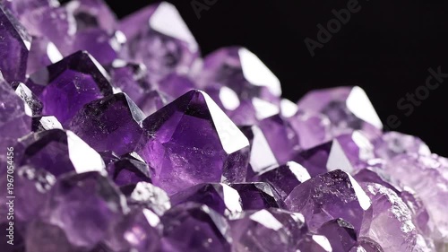 Amethyst crystal cluster on black background.