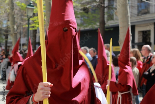 Fotografie Red Holy Week penitent holding palm during Semana Santa procession in Talavera d