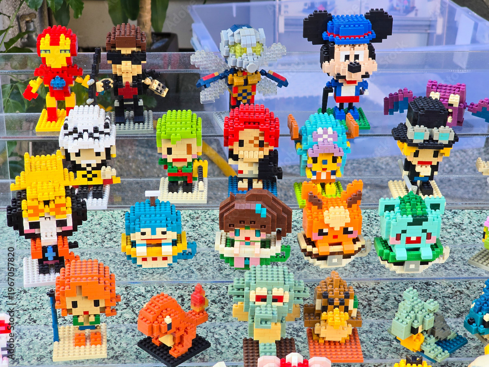 Obraz premium Taiwan, Taipei City, January 3, 2026 – Close-up of LEGO Mickey Mouse, Iron Man, Pikachu, and Anime Figures Outdoors