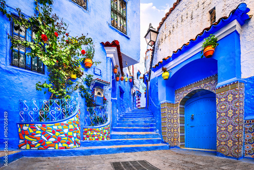 Chefchaouen, Morocco. Blue medina, ancient city, staircase and wall decorated with colourful flowerpots.