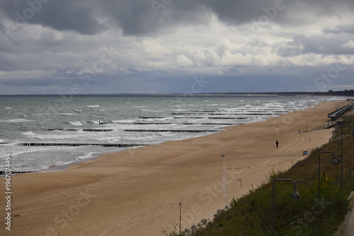 A day marked by overcast skies and brisk winds leaves the Baltic Sea beach in Mielno, Poland, almost empty