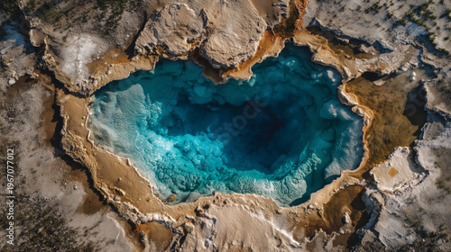 Aerial view of a volcanic crater with a dark blue lake at its center, showcasing rugged terrain and geological formations.