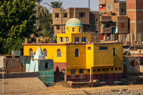Bilde på lerret Colorful riverside building with dome and village houses