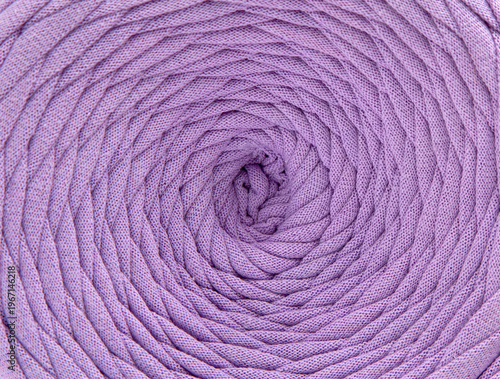 Textured cotton tape  background, rows of yarn for knitting forming geometric patterns and curves.