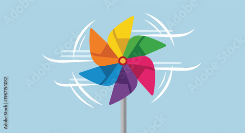 A colorful toy pinwheel spinning rapidly in the wind against a pale blue sky