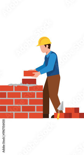A construction worker wearing a yellow hard hat builds a brick wall with mortar