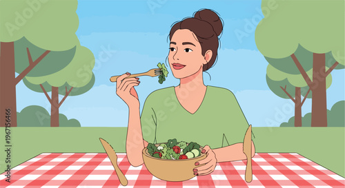 A young woman sits outdoors at a checkered picnic table eating a fresh salad