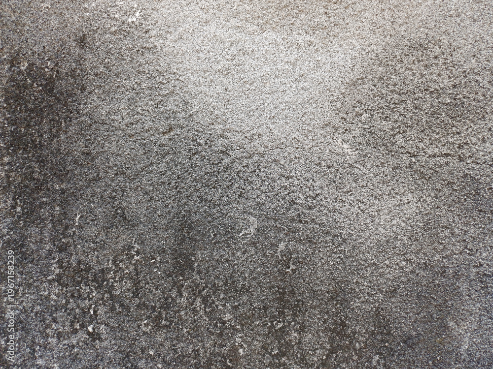 Fototapeta premium Abstract grey grunge wall texture. Rough weathered cement surface with dark moss and mold effects. Industrial old mortar background for creative design.