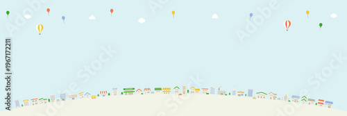 スカイエリアを広く取った街並みパノラマ背景 気球と雲のある構図
