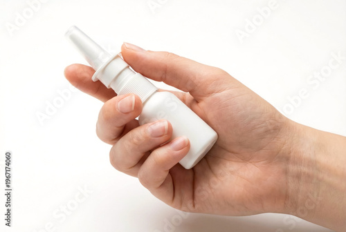 Hand holding a bottle of nasal spray used to relieve breathing and seasonal allergy symptoms caused by pollen. An indispensable medical tool for runny and stuffy noses. 