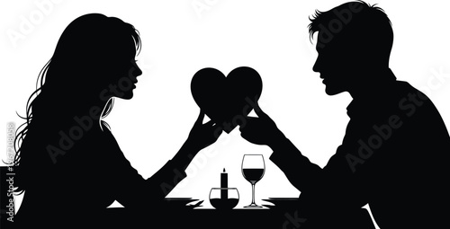 Silhouette of couple sharing a heart during romantic dinner date with candlelight