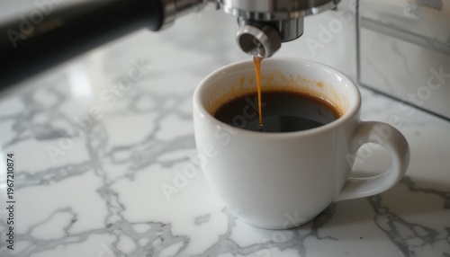 Freshly Brewed Coffee Pouring into a White Ceramic Cup on a Marble Kitchen Countertop