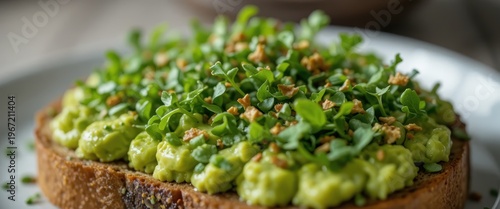Avocado Toast Topped With Fresh Greens and Crispy Garnish Served on a Rustic Wooden Plate