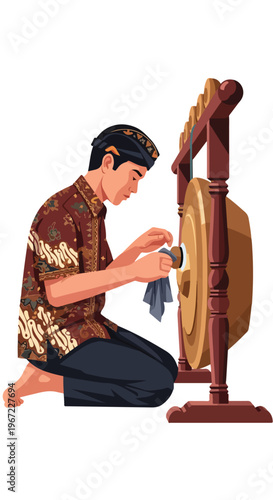 A man in traditional patterned attire kneeling while cleaning a wooden gong set