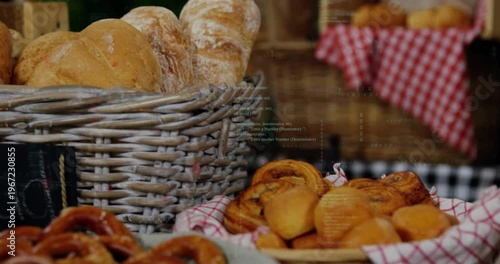 Opening showing wicker basket of pastries on checked cloth as camera panning revealing bakery stall