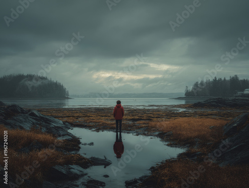 Moody Autumn Landscape: Solitary Silhouette Reflects in Tranquil Lakeview Under Dramatic Overcast Skies in the Pacific Northwest Wilderness