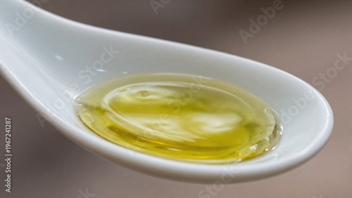 Close Up of Olive Oil on a Spoon Capturing Its Rich Texture and Vibrant Yellow Color