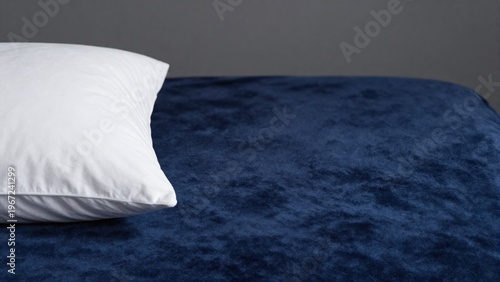 Cozy Blue Bed with Soft Pillow on Dark Fabric Surface in Minimalist Interior Design