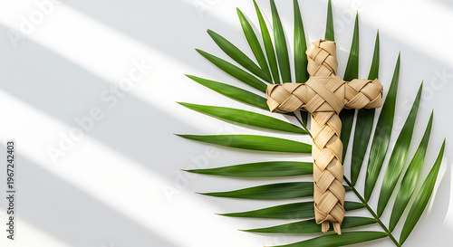 Woven Palm Cross Resting on a Large Green Palm Leaf with Shadows - Easter Symbol