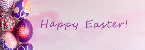 Easter banner with beautiful Easter eggs with flower painted in pink, lilac and violet colors