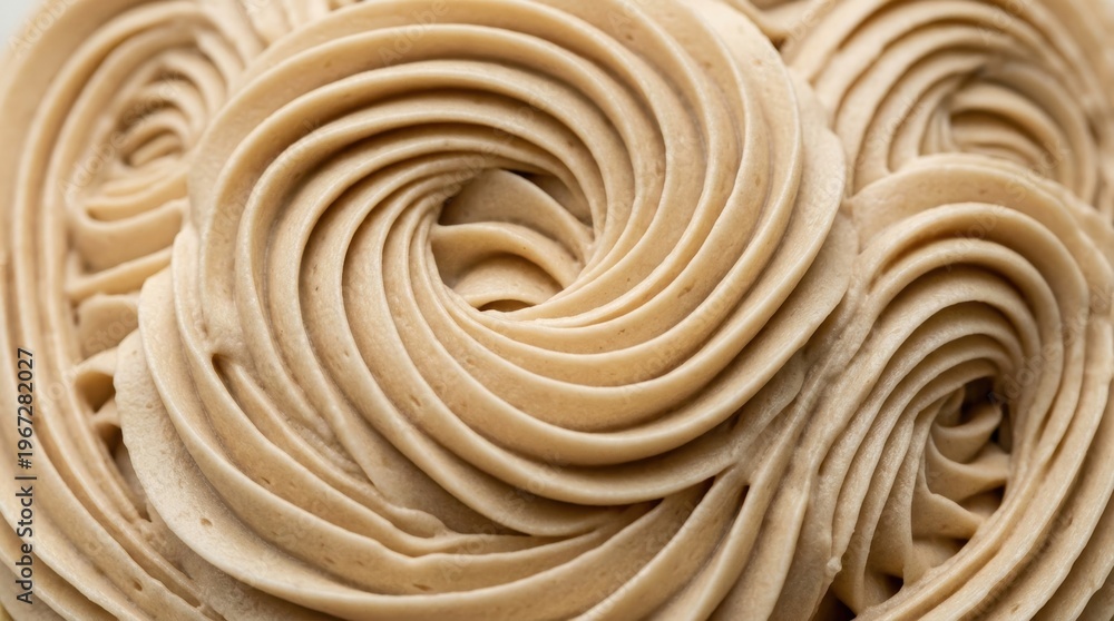 Fototapeta premium Close up view of elegant beige buttercream frosting piped in intricate swirl patterns