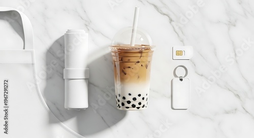 Refreshing Iced Boba Tea with Accessories on a Marble Surface.