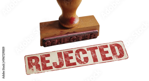 Hand holding rejected stamp over wooden blocks stamp pad