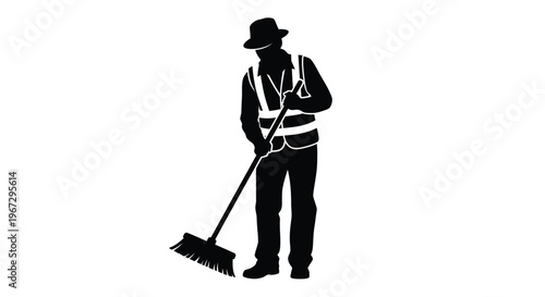 A worker sweeping with a broom depicted as a striking silhouette