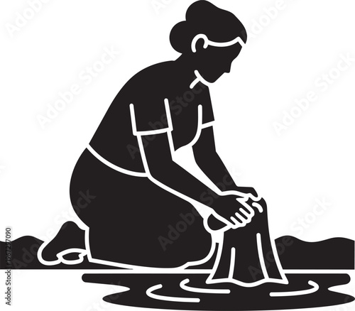 Black silhouette of a woman kneeling and washing clothes in water