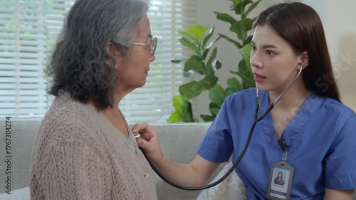 Caregiver elderly care home nurse stethoscope checkup support compassion trust, calm home visit with senior woman on sofa, nurse listening to chest, warm conversation, dignity, comfort in home care