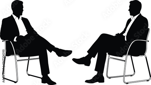 Two businessmen sitting in chairs during a meeting in silhouette.