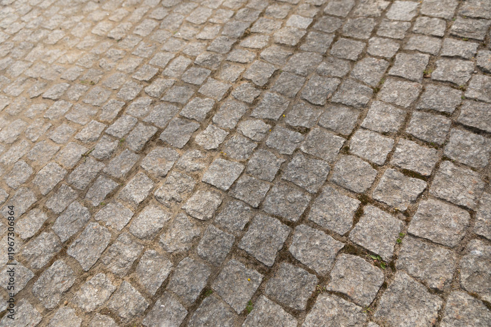 Naklejka premium Cobblestone pavement texture background, urban street pattern.