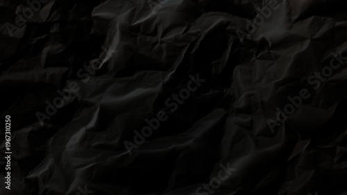 Crumpled black paper texture background with wrinkles and folds abstract dark design element